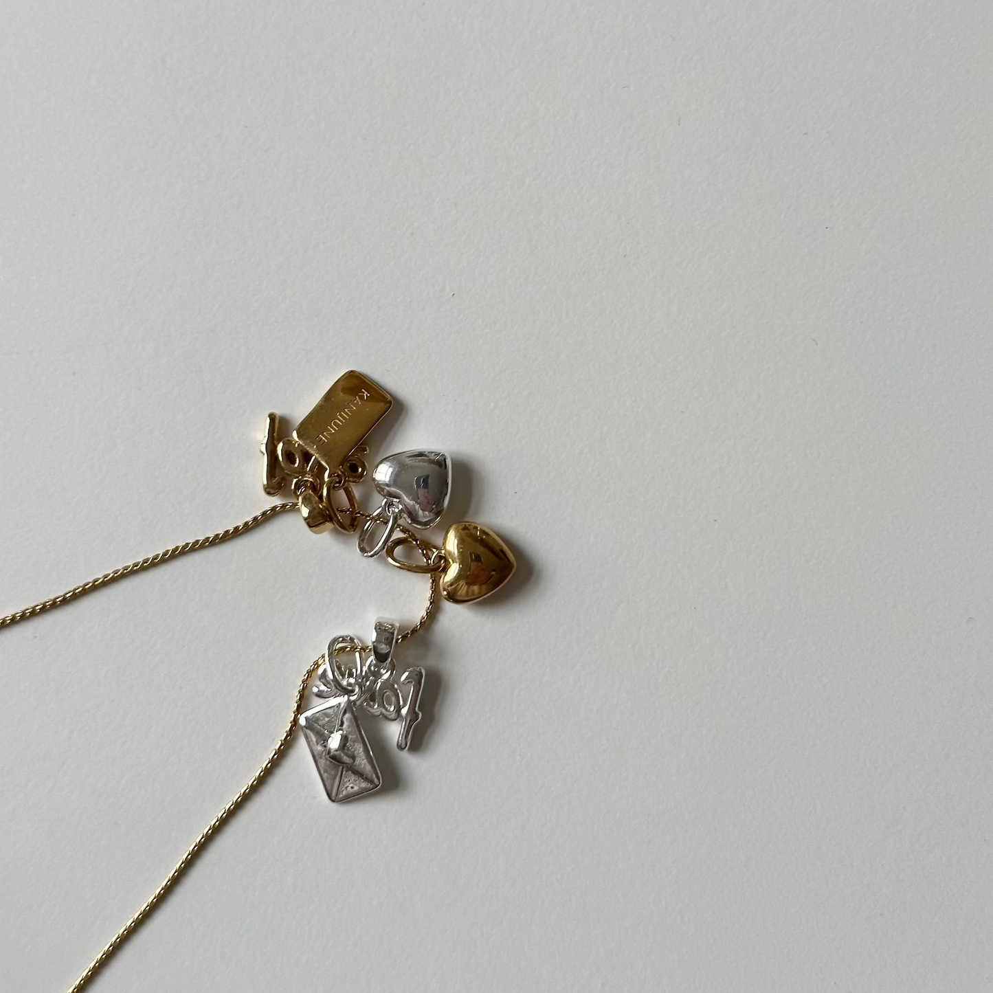 gold necklace worn while holding flowers looking down on the streets