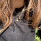 kani necklace and heart of gold necklace in gold worn in sunshine on girl