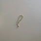 oval charm bracelet in silver on white table with strawberry charm