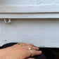 ringe an einer Hand vor Fensterbank