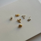 necklace with lots of charms in silver and gold on white table