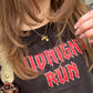 three necklaces worn on woman close up with black shirt